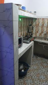 a kitchen with a counter and a sink at Tonton Love in Palimé