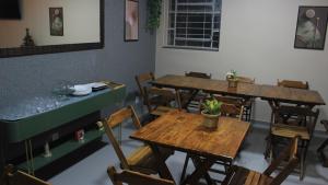 an empty restaurant with wooden tables and chairs at Vintagyn Hostel in Goiânia +34 photos