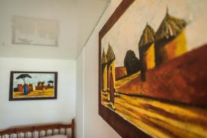 a painting hanging on a wall in a room at Appartement Le Galawa avec les pieds dans l'eau à Saline-les-Bains pour 5 personnes in La Saline les Bains