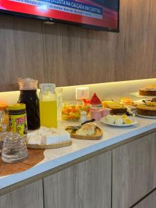 a buffet with a lot of food on a table at Della Economy Hotel in Paranaguá +19 photos