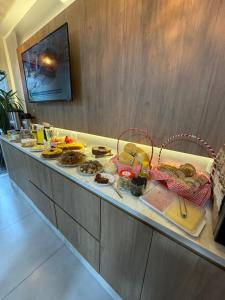a buffet line with many different types of food at Della Economy Hotel in Paranaguá