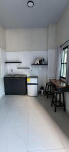 an empty kitchen with a table and a sink at Hotel Sweet Dreams in La Unión