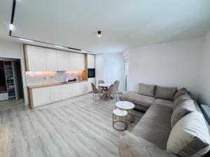 a living room with a couch and a table at Apartman Jaćimović in Doboj
