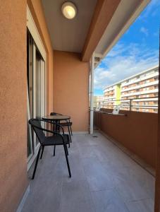 a balcony with a table and chairs on a building at White Homes 1BR - Central Point in Podgorica