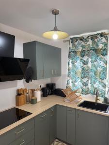 a kitchen with a sink and a counter top at Villa Lissya in Morne-à-lʼEau +7 photos
