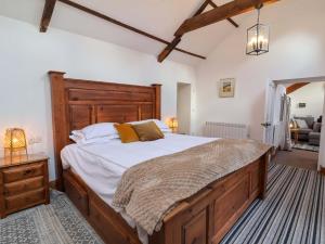 a bedroom with a large bed with a wooden headboard at Baywatch St David's View in Lynton
