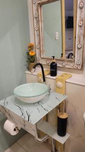 a bathroom with a sink and a mirror at Suíte Cambucá in Praia do Bananal +7 photos