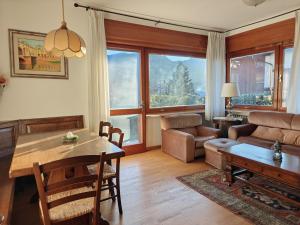 a living room with a table and a couch at Casa Lassù in Pieve di Cadore +22 photos