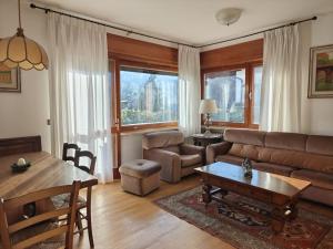 a living room with a couch and a table at Casa Lassù in Pieve di Cadore