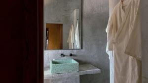 a bathroom with a green sink and a mirror at Lalito in Zipolite