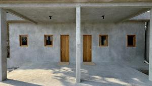 a room with four doors on the side of a building at Lalito in Zipolite