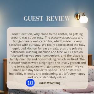 a sign that says guest review in front of a bed at Calm Home Apartment in Mestia