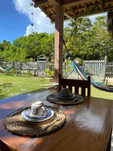a table with two cups and plates on top of it at Odoyá Corumbau in Corumbau