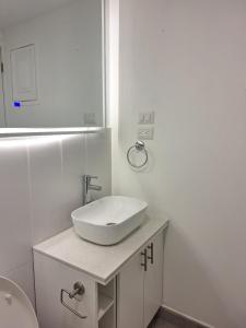a white bathroom with a sink and a toilet at Flamingo zona 4 in Guatemala +15 photos