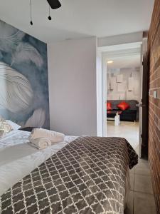 a bedroom with a bed with a mural on the wall at Flamingo zona 4 in Guatemala
