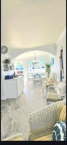 a living room with couches and a table and chairs at Beach Condo in Clearwater Beach