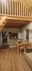 a living room with a table and a kitchen at Domek w Czarnusze in Augustów