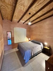 a bedroom with a bed in a room with wooden walls at Refugio del Mar 3 in Ocean Park