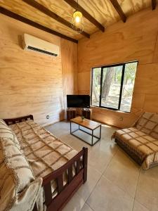 a bedroom with two beds and a table and a couch at Refugio del Mar 3 in Ocean Park