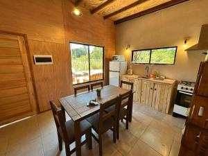 a kitchen with a wooden table and chairs in a kitchen at Refugio del Mar 3 in Ocean Park