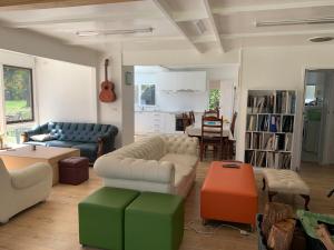 a living room with two couches and a table at Retreat in a beautiful forest! in McMahons Creek