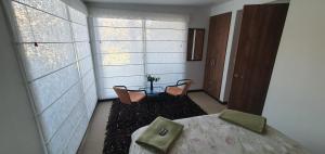 a room with two chairs and a table and a window at Casa del Bosque in Suesca