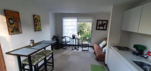 a kitchen and living room with a couch and a table at Casa del Bosque in Suesca +22 photos