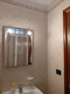 a bathroom with a sink and a mirror at La Terrazza Apartment in Cosenza +38 photos
