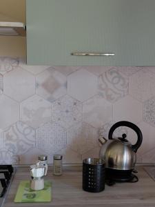 a tea kettle on a stove in a kitchen at La Terrazza Apartment in Cosenza