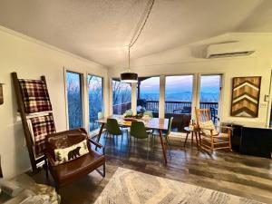 a living room with a dining room table and chairs at Paws at the Peak in Beech Mountain