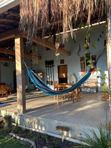 a hammock on a porch of a house at Odoyá Corumbau in Corumbau