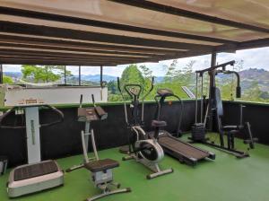 a gym with several exercise equipment in front of a window at Finca Villa Lake in Horizonte