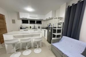 a kitchen with a counter and stools in it at Tyne Haven in San Juan