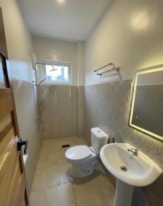 a bathroom with a toilet and a sink at Tyne Haven in San Juan +14 photos