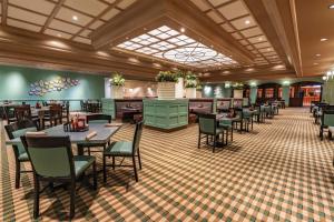 a restaurant with tables and chairs in a room at Masquerade Tower at Rio Hotel & Casino in Las Vegas