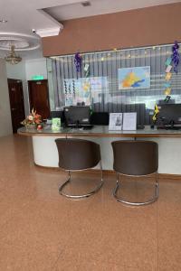 two chairs sitting at a counter in a lobby at Atari Inn Tawau in Tawau