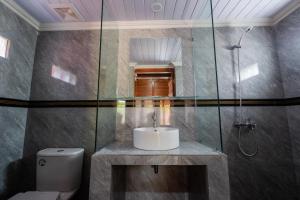 a bathroom with a sink and a shower at Villa Kartikasari in Munduk