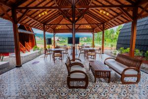 a pavilion with tables and chairs and tables and benches at Villa Kartikasari in Munduk