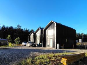 a couple of small buildings parked in a parking lot at Cabaña Valdivia in Valdivia
