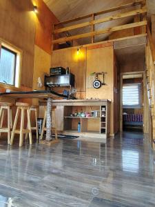 a room with a kitchen with a table and chairs at Cabaña Valdivia in Valdivia +18 photos