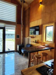 a kitchen with a large wooden table and chairs at Cabaña Valdivia in Valdivia