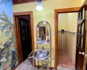 a bathroom with a sink and a mirror at Mirador House Cozy & Private Home W Volcano View in El Castillo de la Fortuna +30 photos
