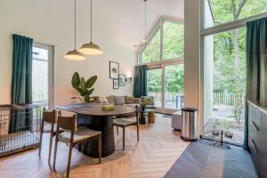a living room with a table and a couch at Landal Olde Kottink in Beuningen +14 photos