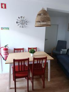 a dining room table with chairs and a potted plant on it at Casa do Ferro de Engomar in Samouco