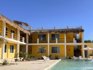 a villa with a swimming pool and a resort at Villas Coral in Dzidzantún