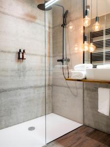 a bathroom with a shower and a sink at Hotel City Maribor in Maribor