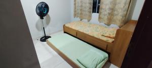 two bunk beds in a room with a fan at Doce lar in Búzios