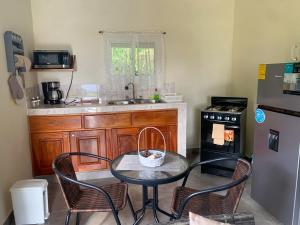 a kitchen with a table and chairs and a refrigerator at Venus Lodging House in Alto Boquete