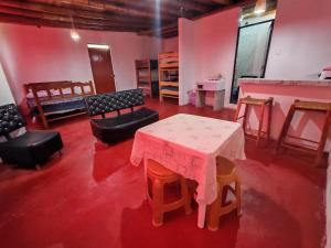 a room with a table and some chairs and a table andools at Casita de camucha segundo piso in Chincha Baja +2 photos