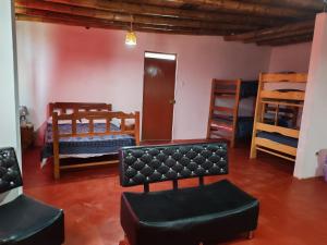 a living room with bunk beds and a couch and chairs at Casita de camucha segundo piso in Chincha Baja